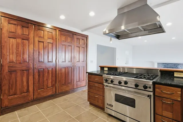 a stove top oven sitting inside of a kitchen