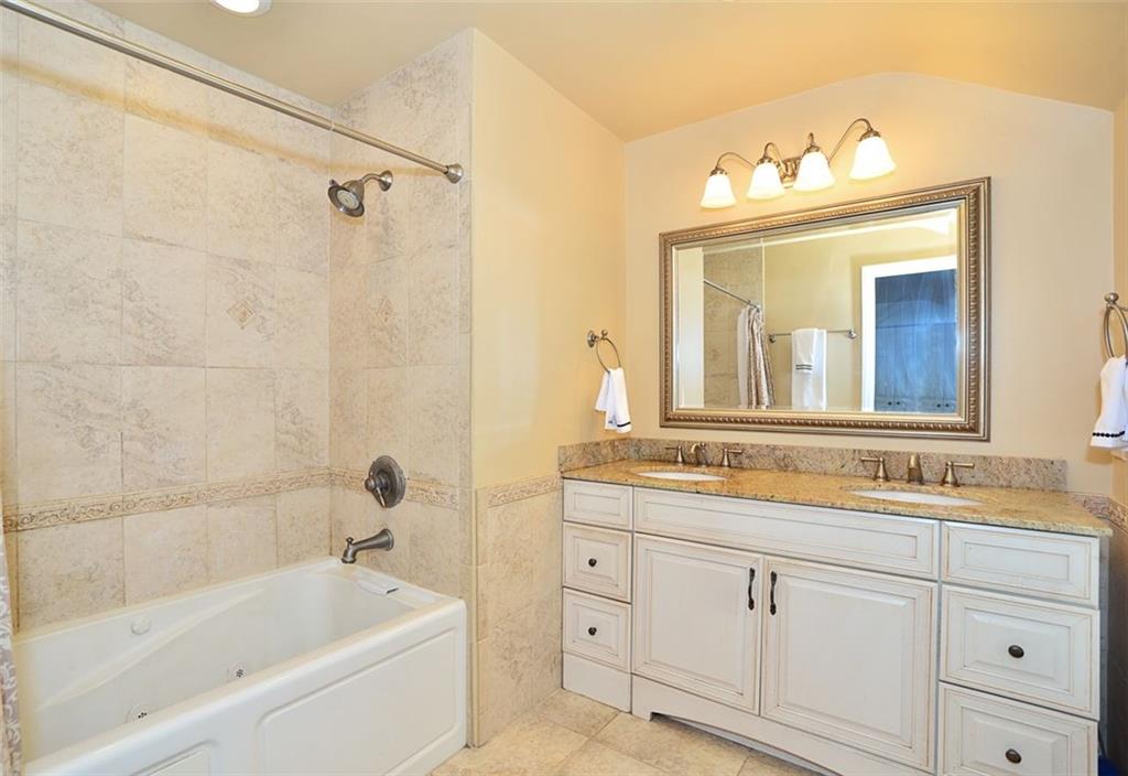 10550 Grubbs Road Wexford, PA 15090 - Photo 14 of 25 Remodeled master bathroom offers whirlpool tub, newer vanity with granite counter top ,newer fixtures and ceramic tiled walls and flooring.