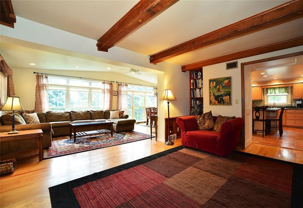 10550 Grubbs Road Wexford, PA 15090 - Photo 8 of 25 Beamed family room with log burning fireplace and hardwood floors open to the sunroom.