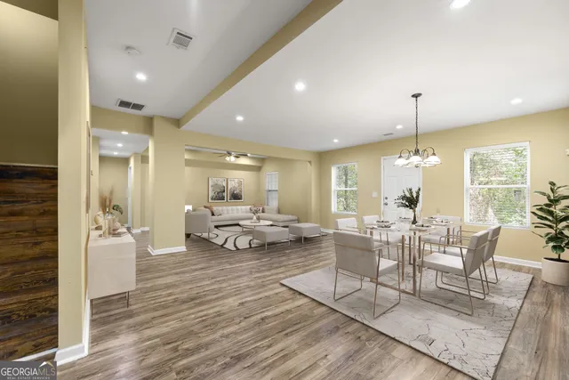 a view of a livingroom with furniture window and wooden floor