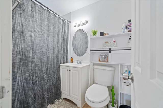 a white toilet sitting next to a bathroom sink