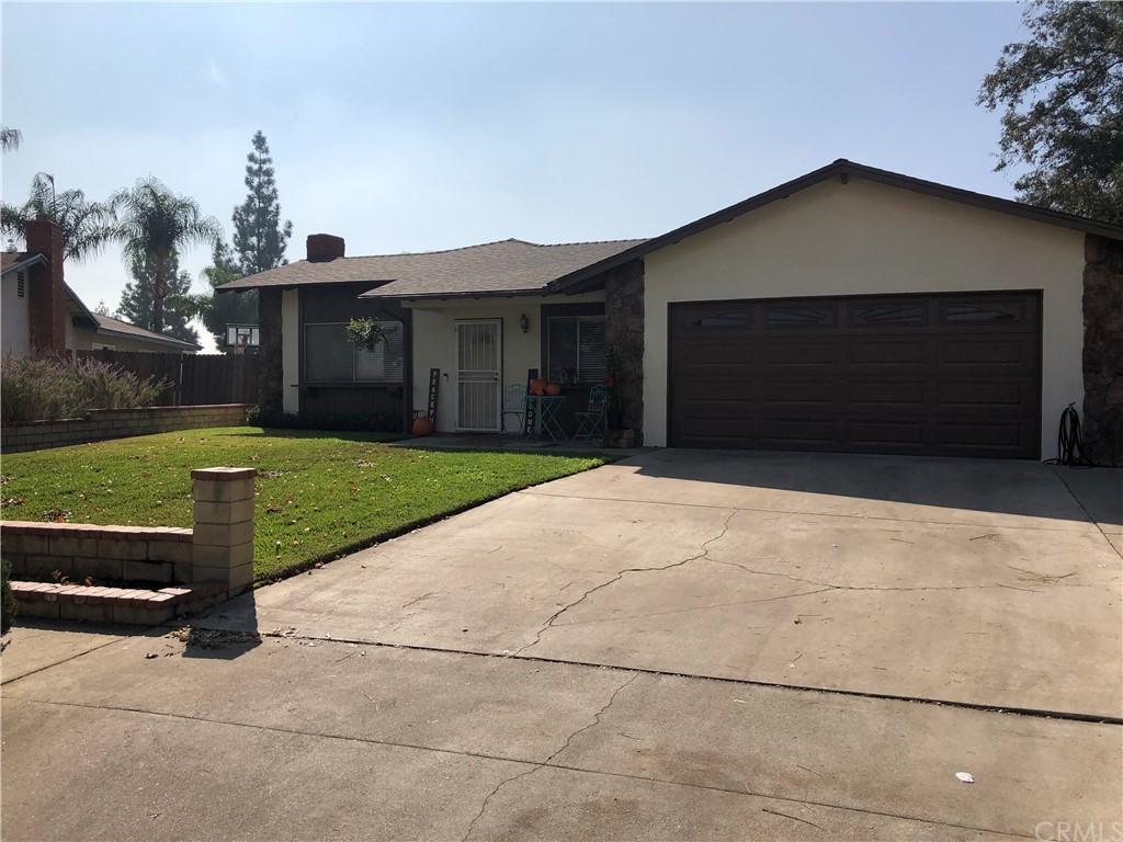 9951 Candlewood Street Rancho Cucamonga, CA 91730 - Photo 1 of 1 a front view of a house with a yard and garage