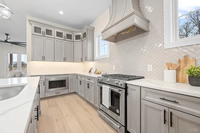 a kitchen with granite countertop a stove oven and sink