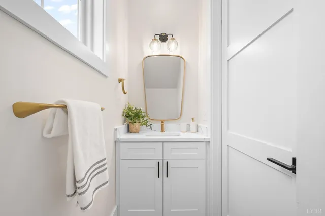 a bathroom with a sink a mirror and vanity