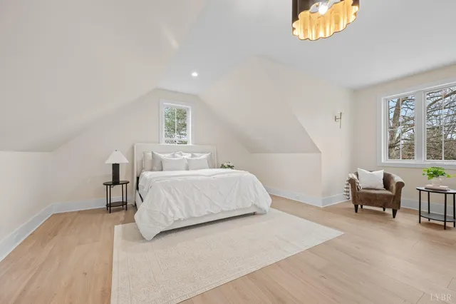 a bedroom with a bed and a chandelier