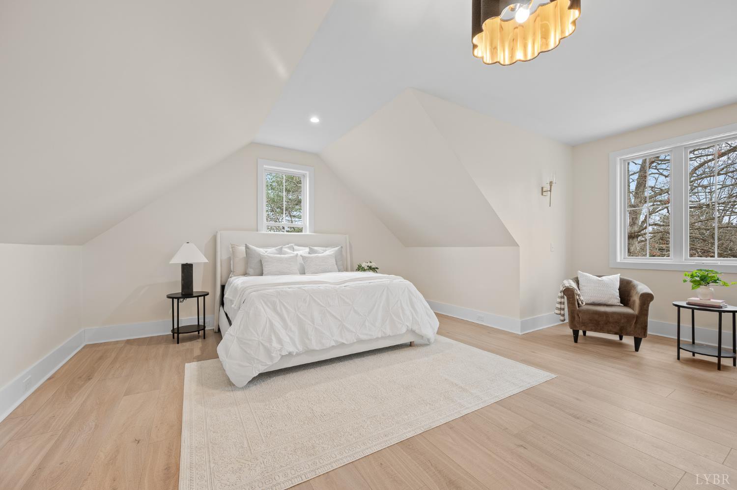 3741 Lowry Road Goode, VA 24556 - Photo 15 of 54 a bedroom with a bed and a chandelier