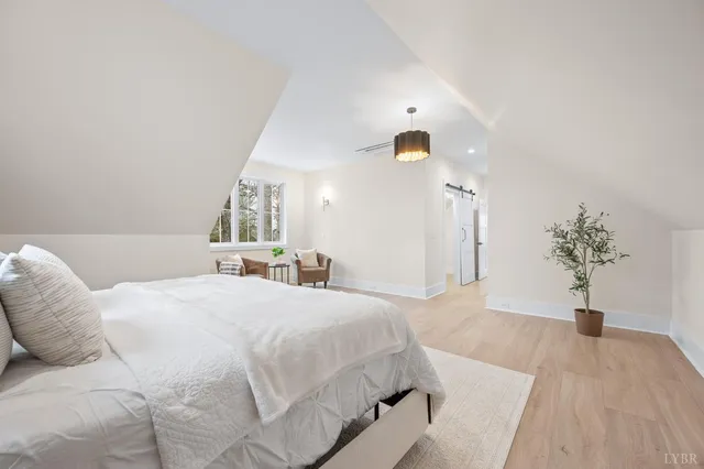 a bedroom with a bed and a potted plant