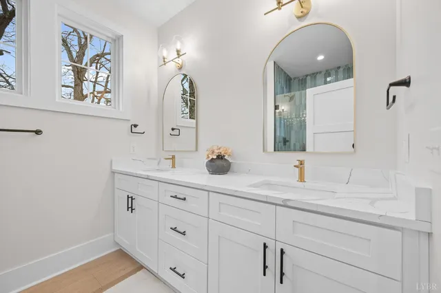 a bathroom with a double vanity sink and a mirror