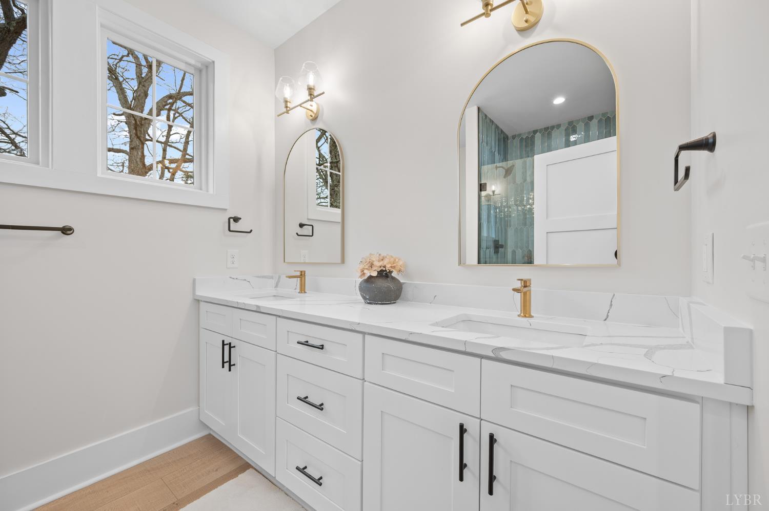 3741 Lowry Road Goode, VA 24556 - Photo 21 of 54 a bathroom with a double vanity sink and a mirror