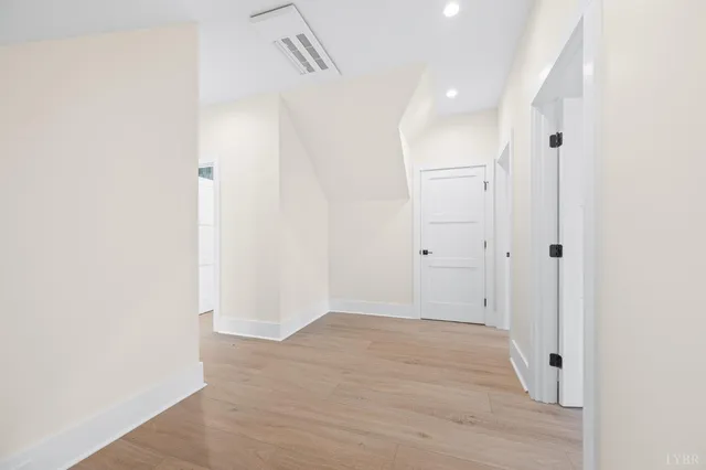 a view of a hallway with wooden floor