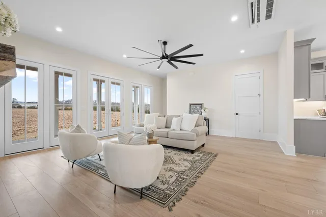 a living room with furniture and wooden floor