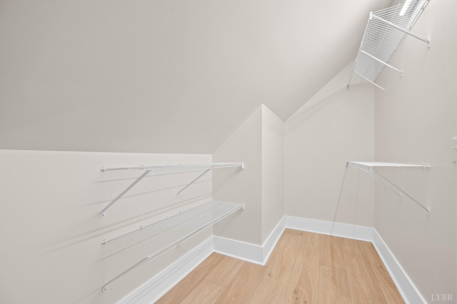 3741 Lowry Road Goode, VA 24556 - Photo 31 of 54 a view of walk in closet with empty racks