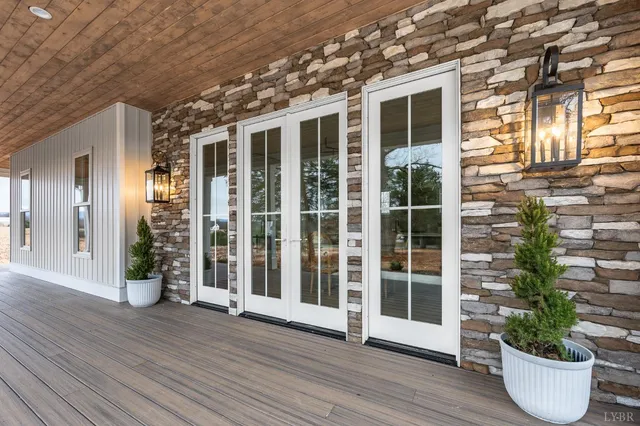 a view of a house with a potted plant and floor to ceiling windows