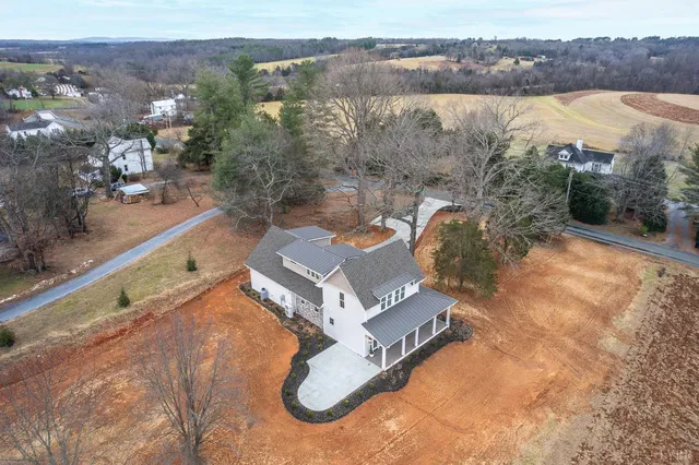 an aerial view of a house with a lake view
