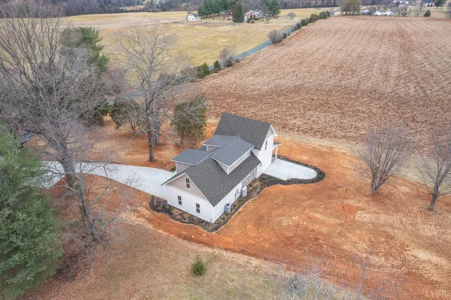 a view of a yard with large trees
