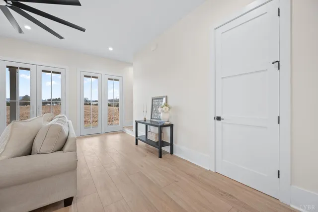 a living room with furniture and a wooden floor