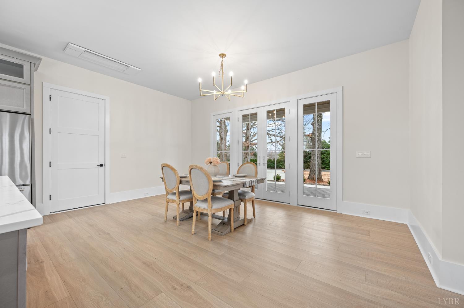 3741 Lowry Road Goode, VA 24556 - Photo 7 of 54 a dining room with furniture a chandelier and wooden floor