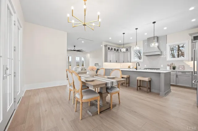 a large kitchen with a table and chairs