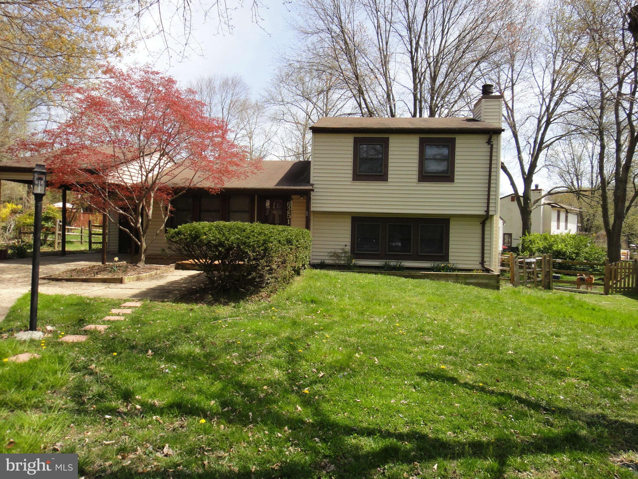 6251 Parallel Lane Columbia, MD 21045 - Photo 2 of 28 a front view of a house with a yard and garage
