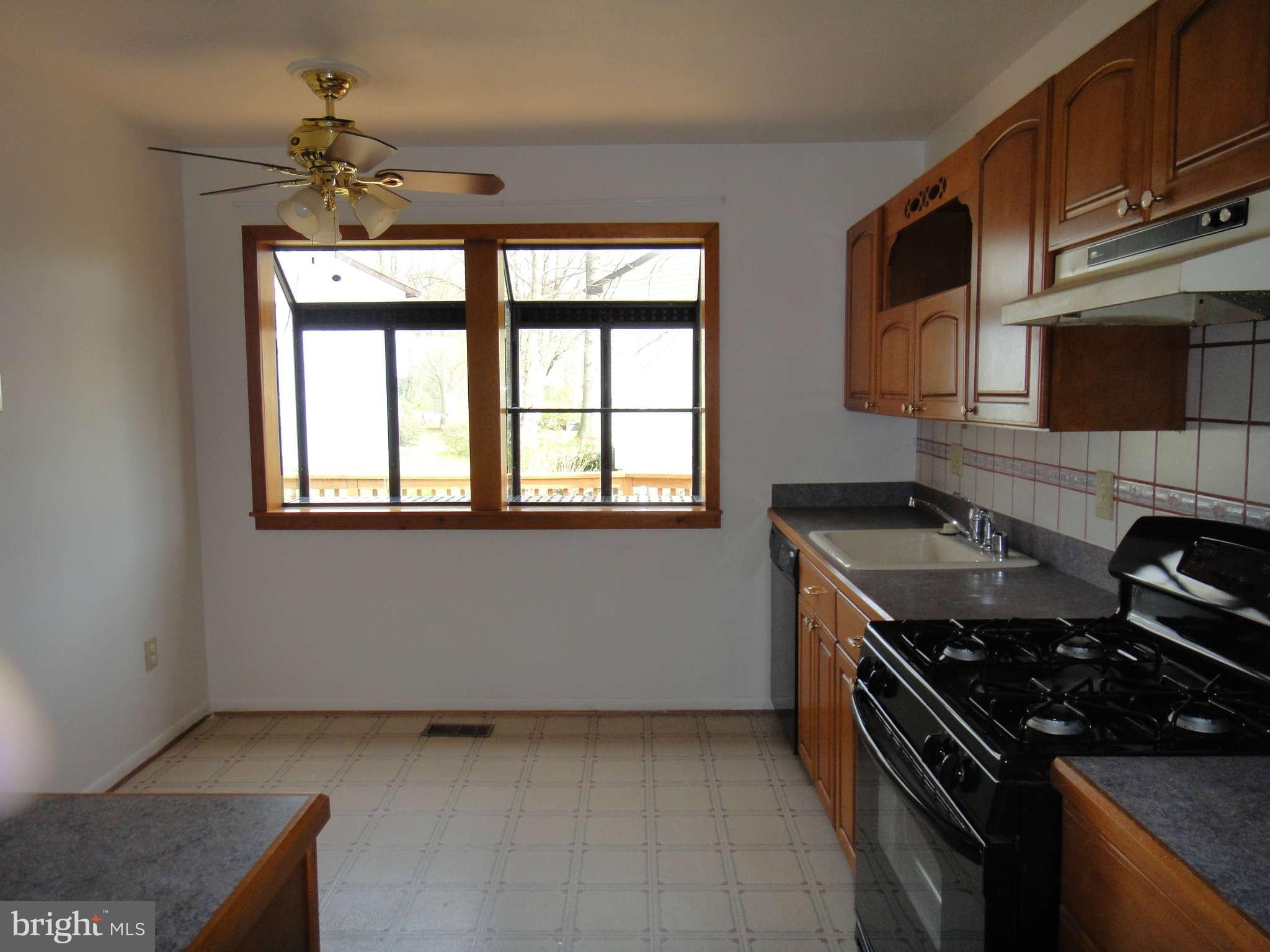 6251 Parallel Lane Columbia, MD 21045 - Photo 5 of 28 a kitchen that has a stove and a microwave