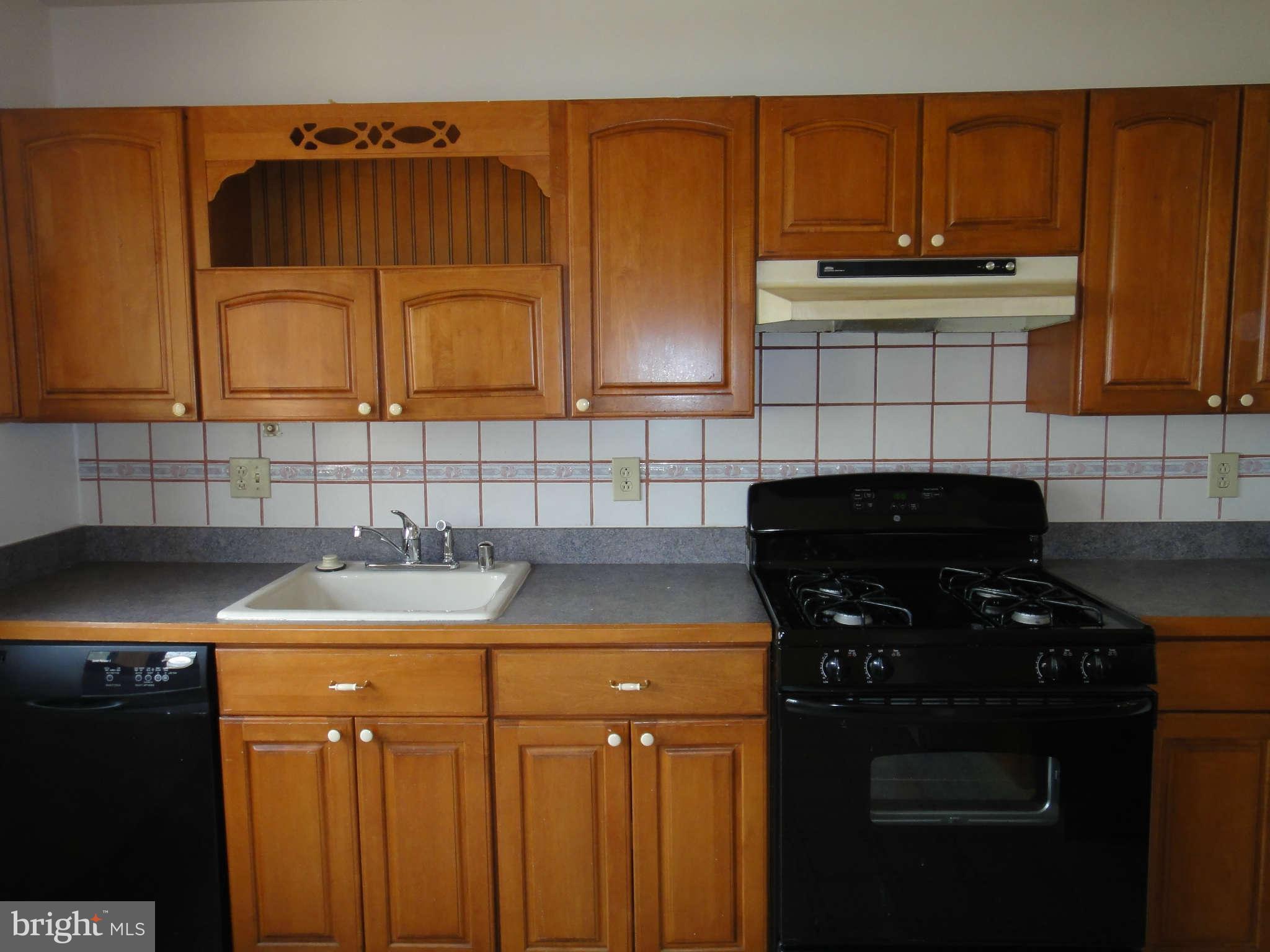 6251 Parallel Lane Columbia, MD 21045 - Photo 6 of 28 a kitchen with a sink a stove and cabinets