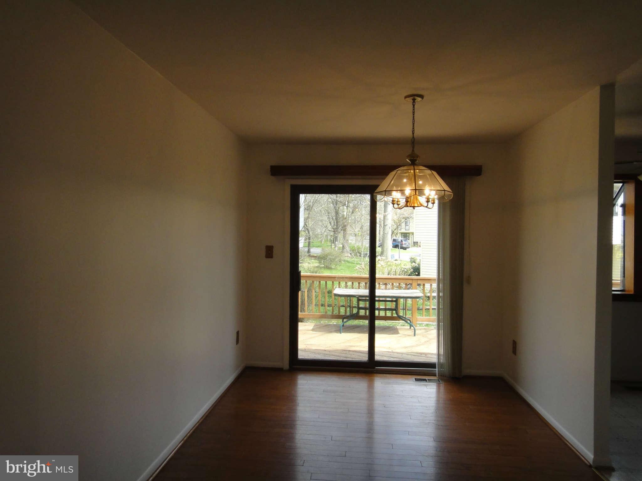 6251 Parallel Lane Columbia, MD 21045 - Photo 9 of 28 a view of a room with wooden floor chandelier and windows