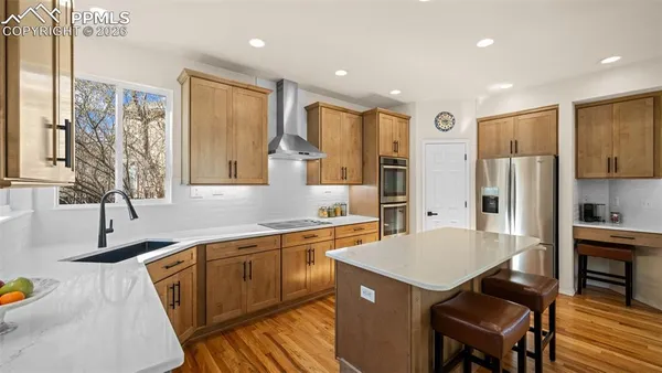 a kitchen with a sink refrigerator and cabinets