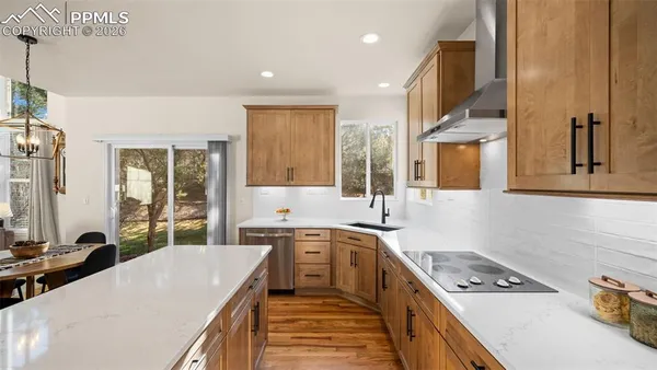 a kitchen with stainless steel appliances a sink stove and cabinets