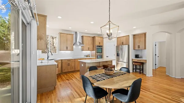 a large kitchen with a table and chairs