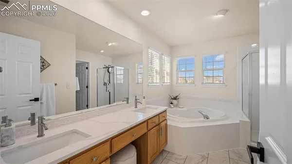 a bathroom with a tub sink and mirror