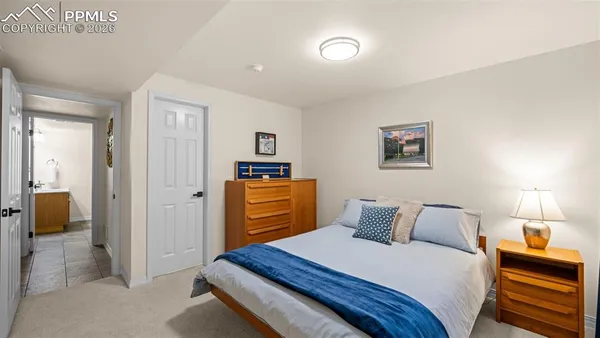 a bedroom with bed and painting on the wall