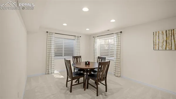 a view of a dining room with furniture and a window