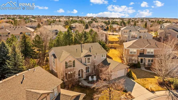 an aerial view of residential houses with outdoor space and parking