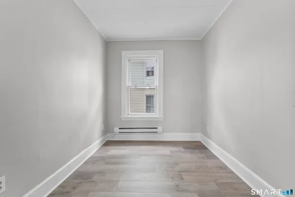 a view of a livingroom with wooden floor and a window