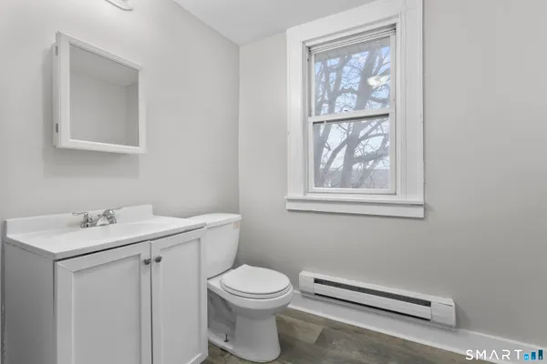 a bathroom with a toilet a sink and shower