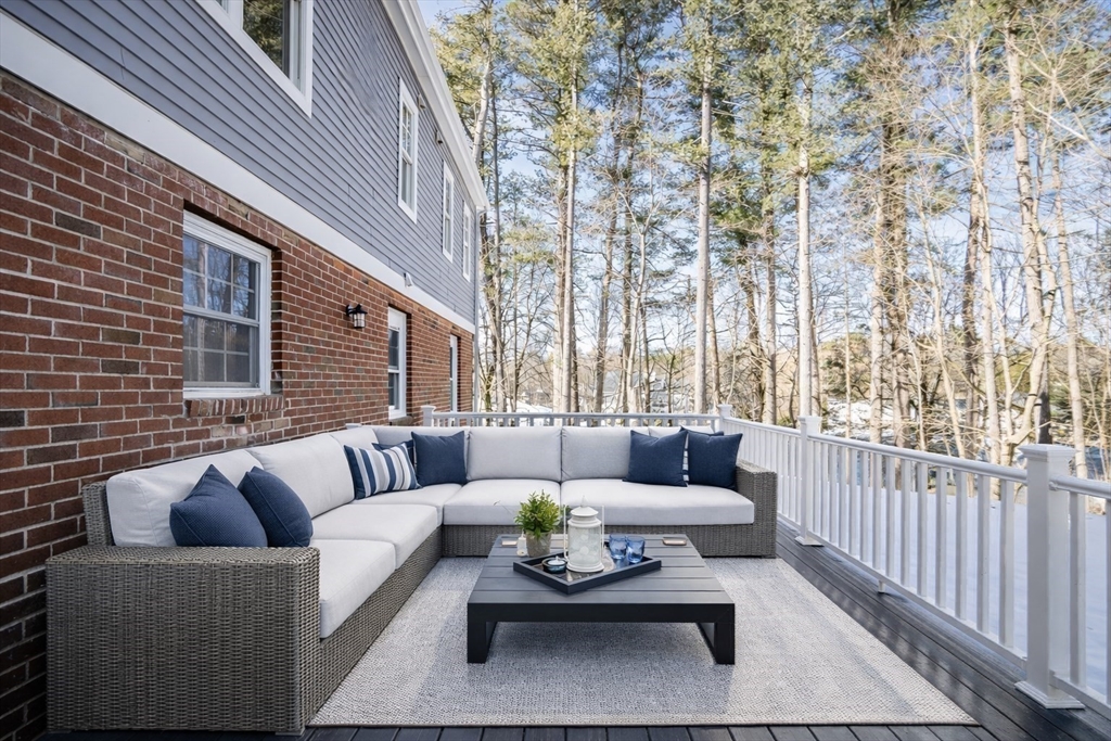 510 Common Street Walpole, MA 02081 - Photo 27 of 35 a view of a patio with couches and a table and chairs with wooden floor