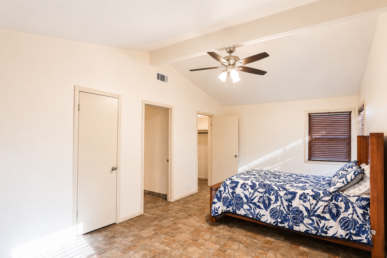 1508 Walnut Street Georgetown, TX 78626 - Photo 25 of 37 A well-lit bedroom features vaulted ceilings and practical tiled flooring for easy maintenance.