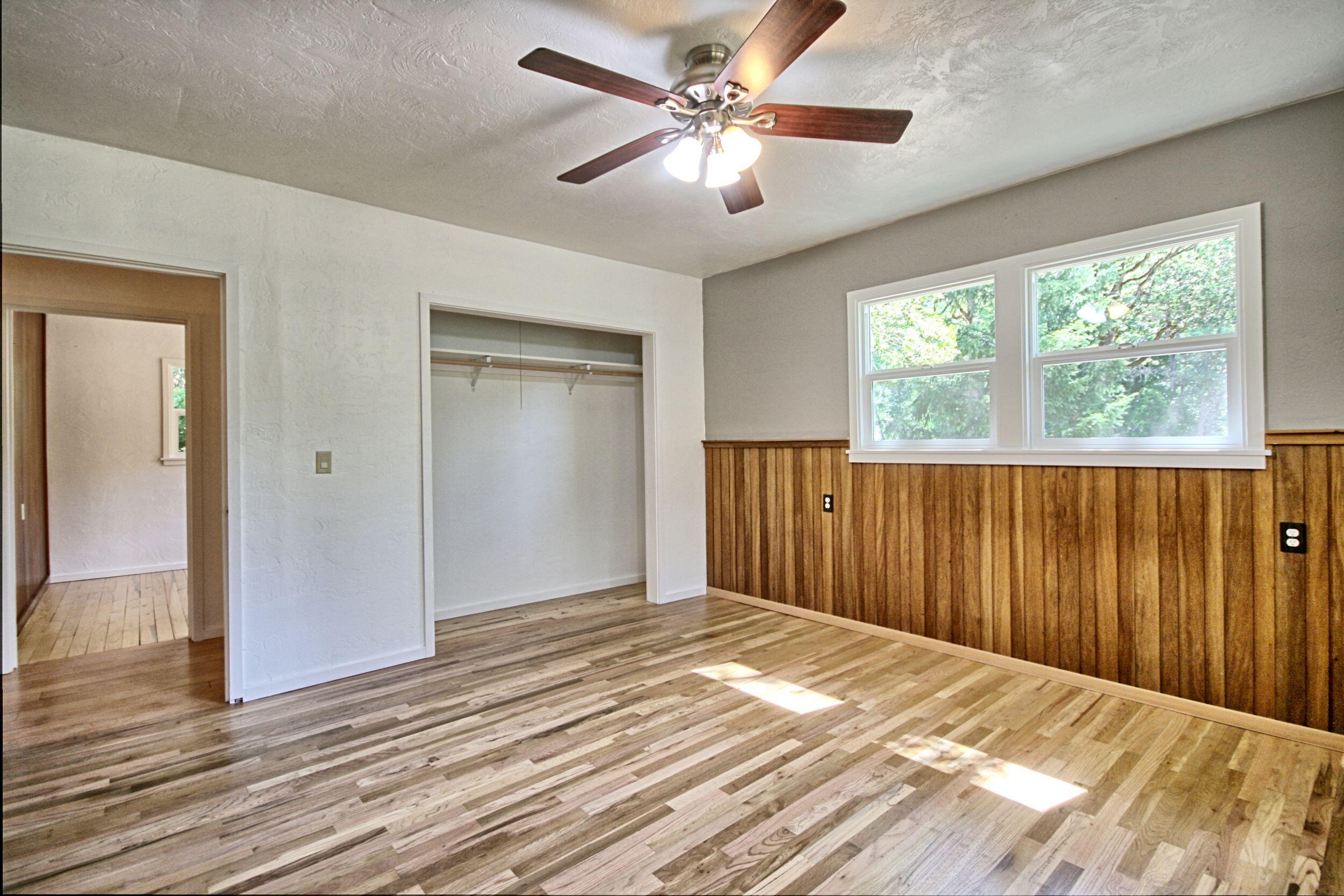 199 Powell Creek Road Williams, OR 97544 - Photo 29 of 57 wooden floor in an empty room with a window