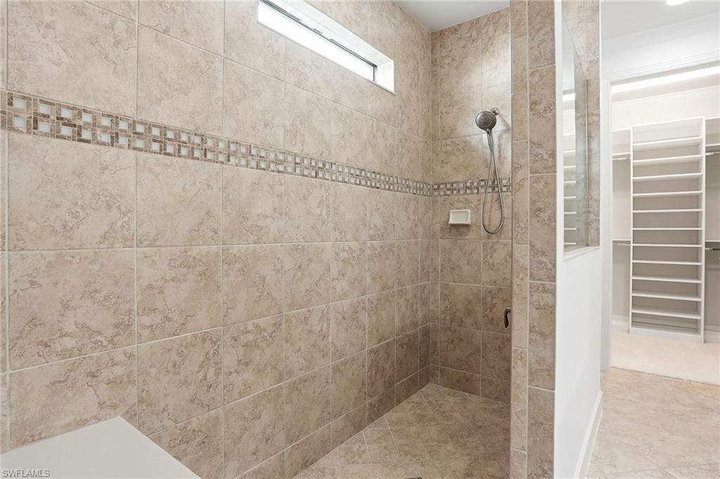 9436 Whooping Crane Way Naples, FL 34120 - Photo 11 of 32 a bathroom with a shower