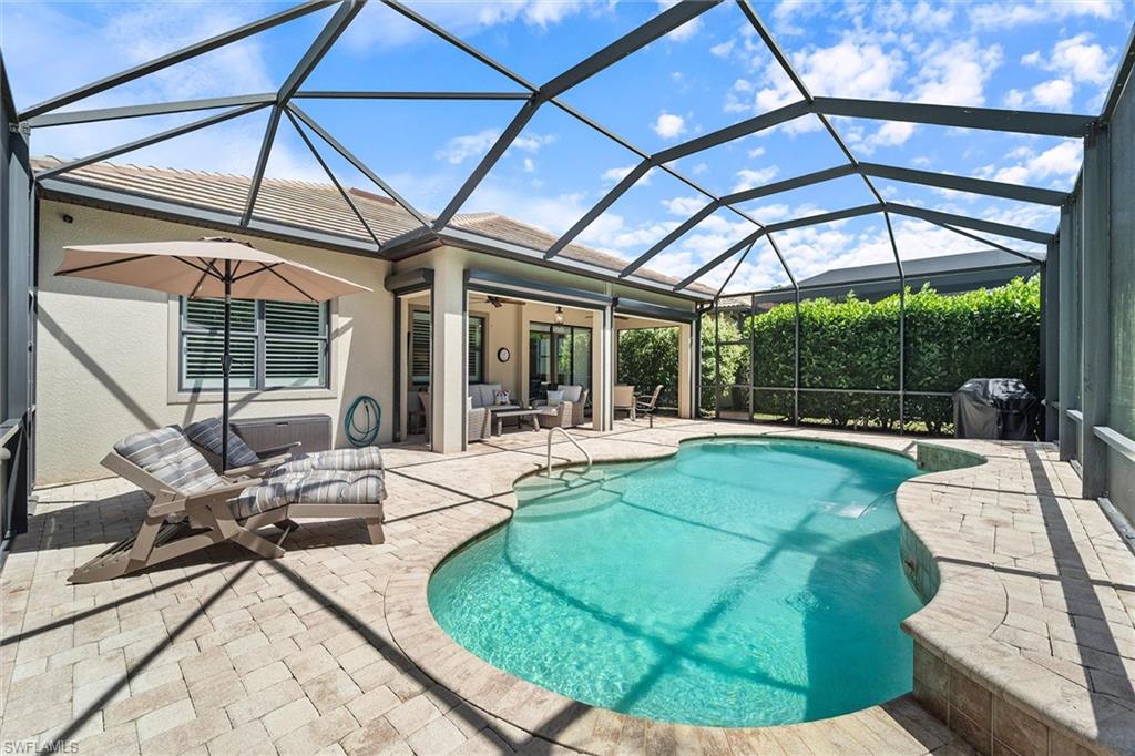 9436 Whooping Crane Way Naples, FL 34120 - Photo 17 of 32 a view of a swimming pool with a patio