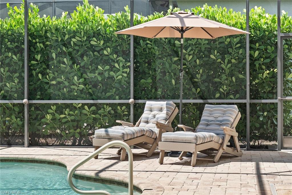 9436 Whooping Crane Way Naples, FL 34120 - Photo 19 of 32 a balcony with table and chairs