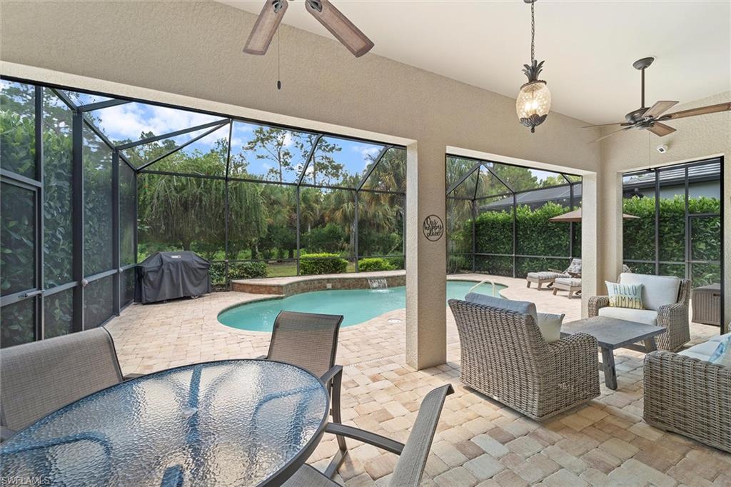 9436 Whooping Crane Way Naples, FL 34120 - Photo 20 of 32 a living room with furniture and a floor to ceiling window