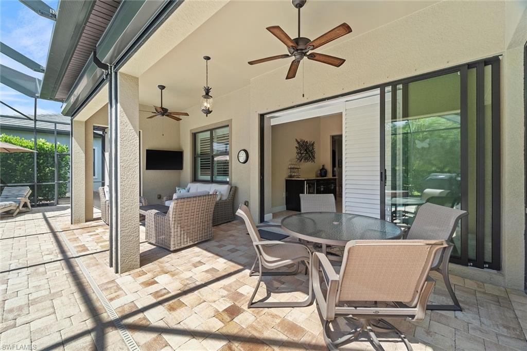 9436 Whooping Crane Way Naples, FL 34120 - Photo 21 of 32 a view of a dining room with furniture window and wooden floor
