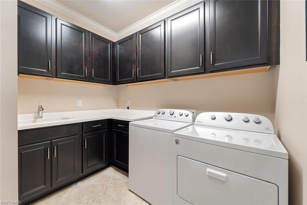 9436 Whooping Crane Way Naples, FL 34120 - Photo 22 of 32 a utility room with dryer and washer