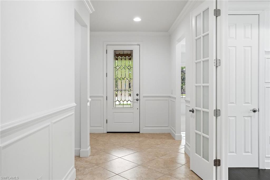9436 Whooping Crane Way Naples, FL 34120 - Photo 3 of 32 a view of a hallway with entryway and front door