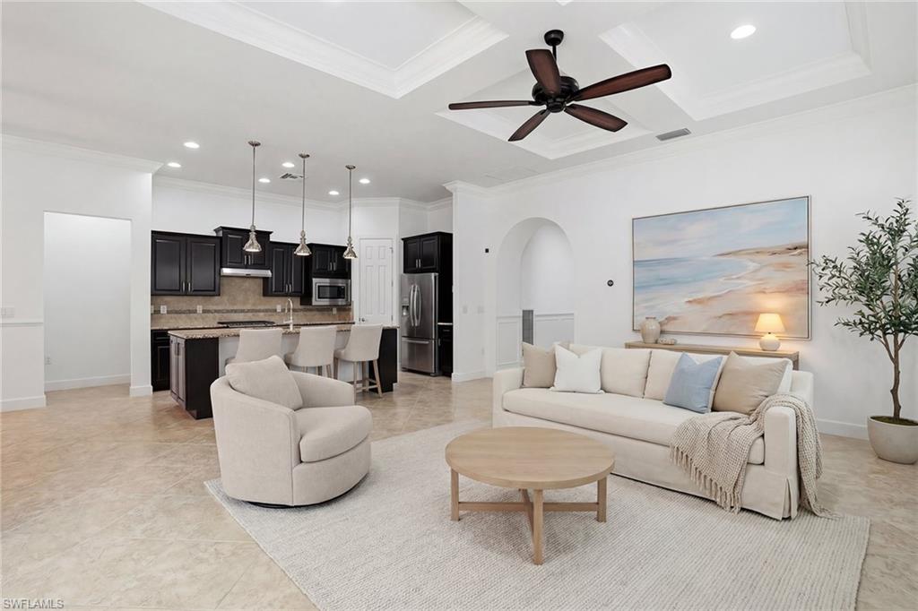 9436 Whooping Crane Way Naples, FL 34120 - Photo 7 of 32 a living room with furniture and kitchen view