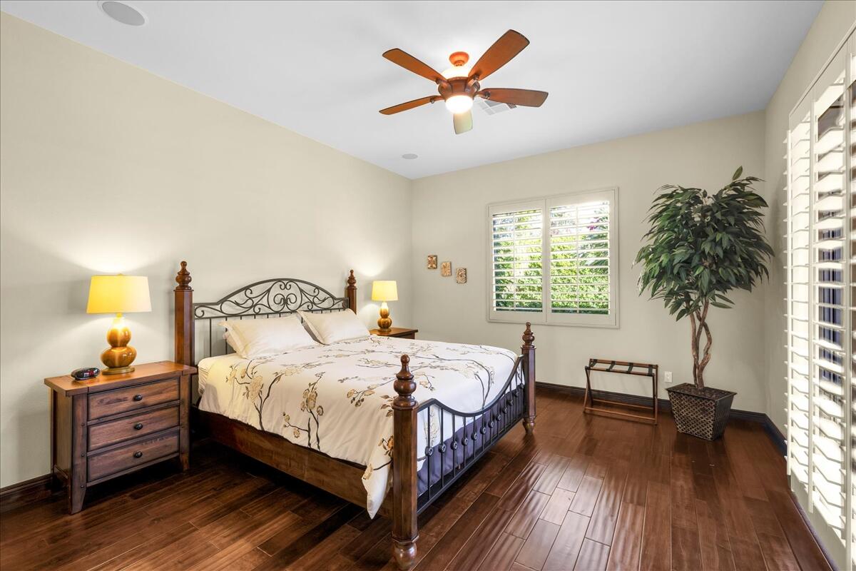 58 Payson Circle Palm Desert, CA 92211 - Photo 20 of 41 a bedroom with a bed and a large window with wooden floor