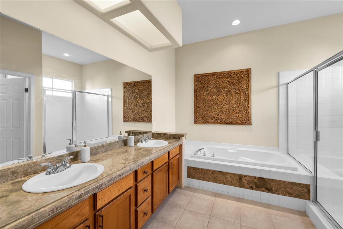 58 Payson Circle Palm Desert, CA 92211 - Photo 23 of 41 a bathroom with a granite countertop tub sink and mirror
