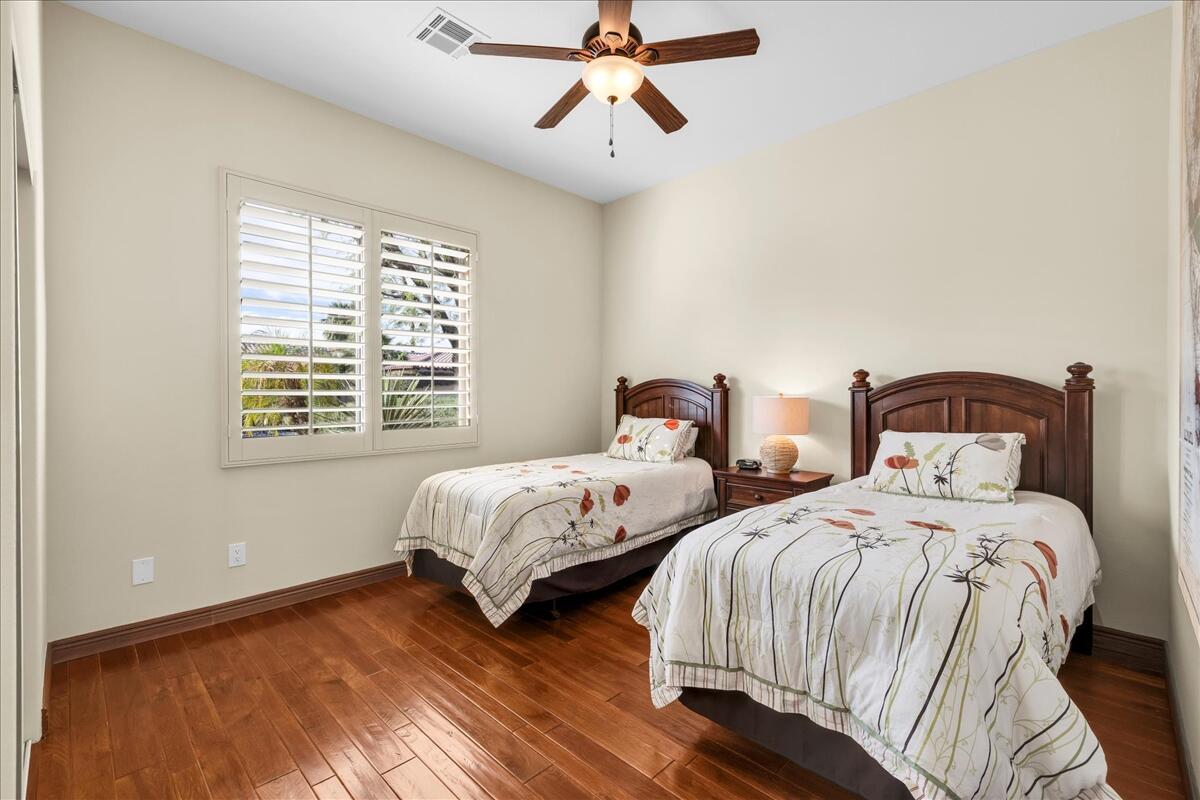 58 Payson Circle Palm Desert, CA 92211 - Photo 27 of 41 a bedroom with two beds and wooden floor