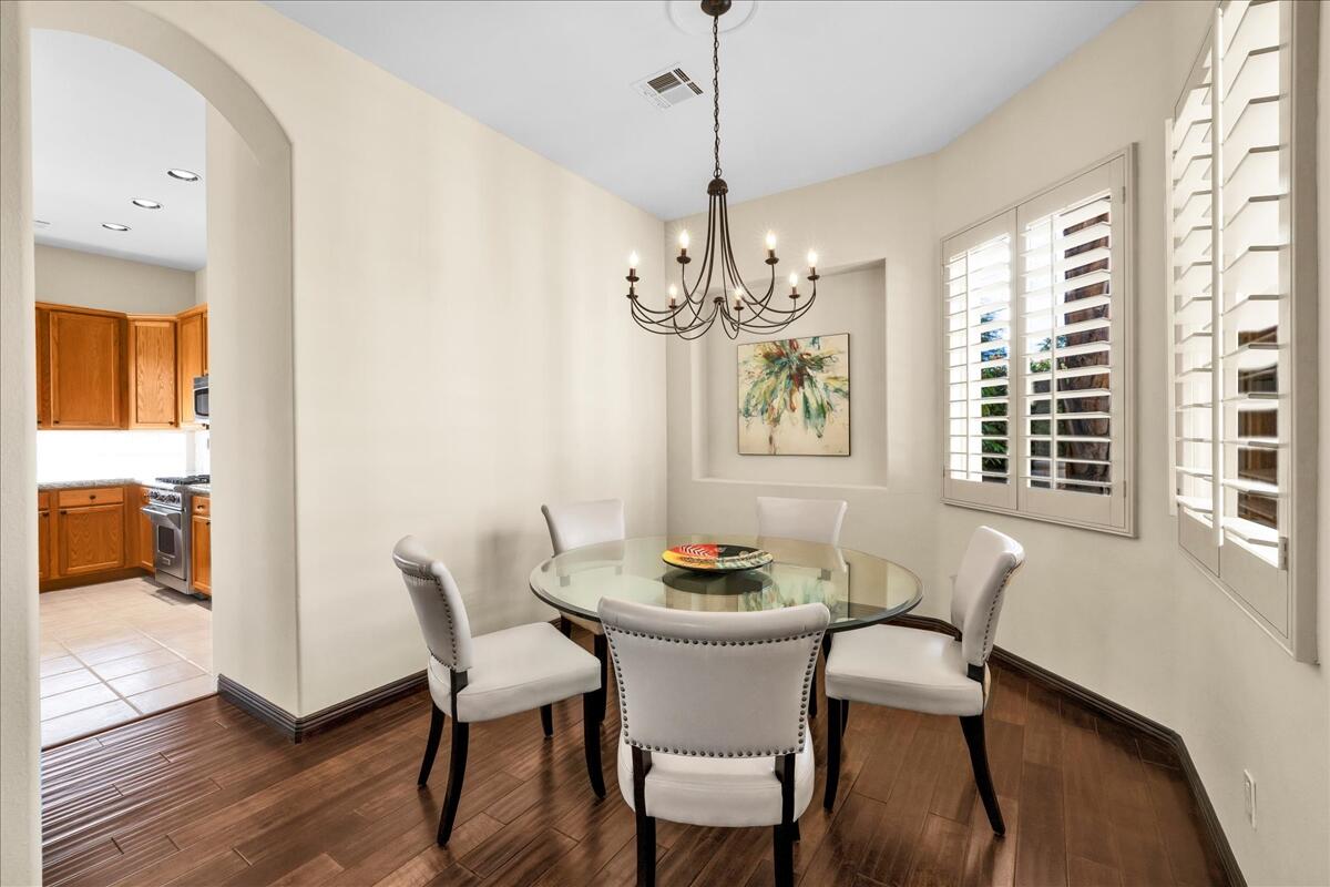 58 Payson Circle Palm Desert, CA 92211 - Photo 10 of 41 a dining room with furniture a chandelier and wooden floor